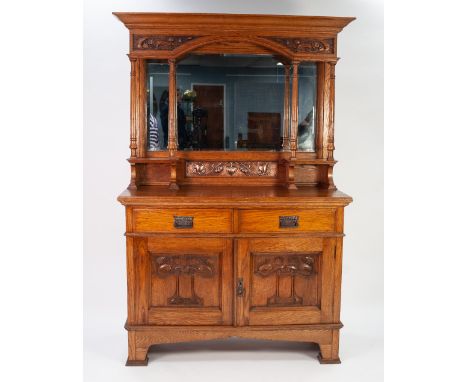 EARLY TWENTIETH CENTURY ARTS AND CRAFTS CARVED OAK MIRROR BACK SIDEBOARD, the canopy top with moulded cornice and stylised fl