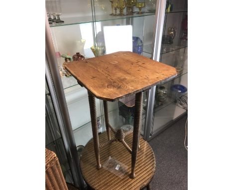 A stripped pine Arts and Crafts table, square top over ring turned legs, the cross stretcher with 'Bee Skep' boss to centre, 