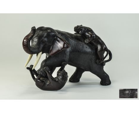 A Japanese 19th Century Fine and Impressive Heavy Bronze Sculpture of a Large Elephant Being Attacked by Two Tigers. Signed t