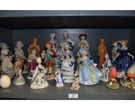 A shelf full of figurines, Including IVO and staffordshire style pieces.