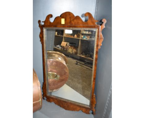 A Chippendale style early 20th century mahogany and walnut wall mirror having gilded beading.