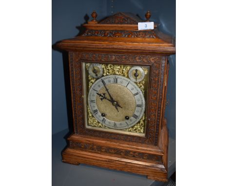A late 19th century oak cased bracket clock having silver face with roman numerals and striking movement.