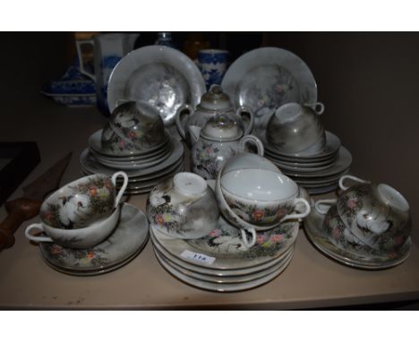 A hand decorated Japanese Egg shell tea service, having stork and floral design, plates, cups and saucers and more included.