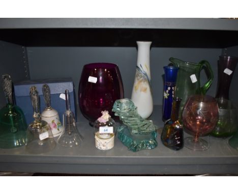 A variety of glass including an unusual candlestick holder, colourful pieces and bells.