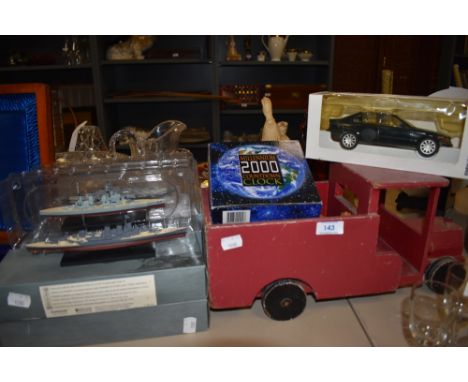 A wooden truck, a boxed model BMW 325i and a millennium clock.