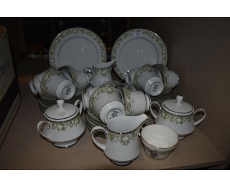 A part Noritake dinner service having muted green floral transfer pattern and silver gilt edging,includes sugar bowls, jug, a
