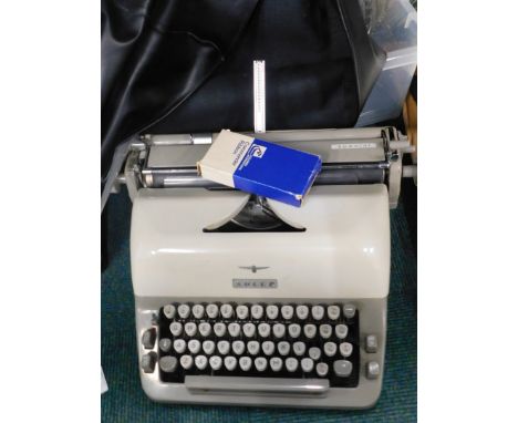 An Adler portable typewriter with a A.J. Todd &amp; Co Ltd Lincoln cover, and a selection of glassware.