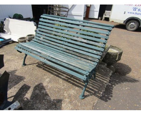 Green bench with cast iron ends and wooden slats