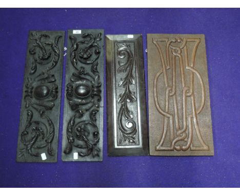A pair of late Victorian dark oak carved furniture panels and two similar including Celtic design