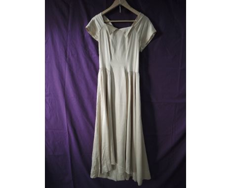An antique full length champagne coloured gown, having button back fastening, good condition, slight wear in places