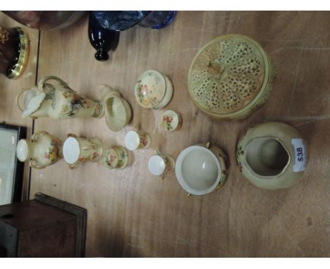 Seven Royal Worcester trinkets, having gilt heightened floral decoration on blush ground, including tyg, cauldron and miniatu