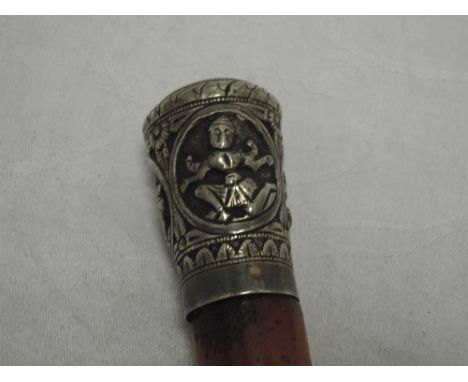 A walking stick having white metal knop with Indian decoration, no marks tested as silver