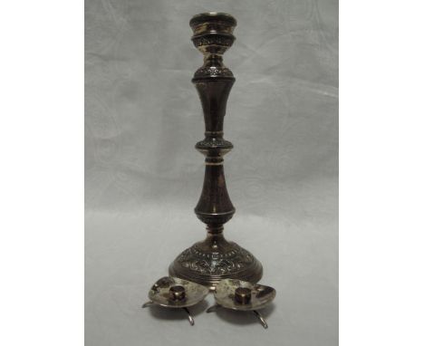 A silver candlestick of waisted tapered column form having moulded scroll decoration to base, Birmingham 1967, W I Broadway &