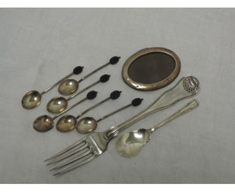 A small selection of HM silver including coffee spoons, small oval photograph frame, jam spoon and a white metal table fork b