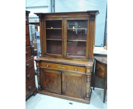 A 19th century Continental rosewood cabinet having glass display top flanked by corinthian inspired pillars over desk drawer 