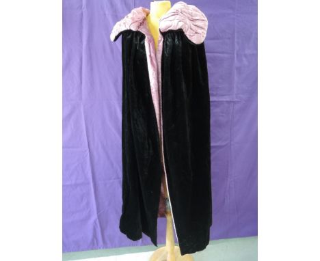 An antique cloak in pink and black velvet, good condition