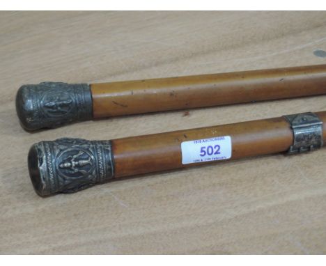 A pair of near matching walking canes having white metal embossed knops of Indian designSILVER KNOPS BASHEDCANE STICK IN USED