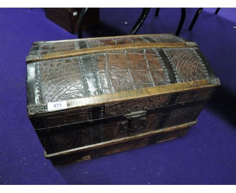 A late Victorian wood band dome top trunk of small size having studded embossed leather panels