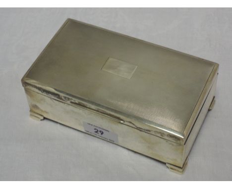 A silver cigarette box having engine turned decoration, plain cartouche and bracket feet, Birmingham 1965, Francis Howard