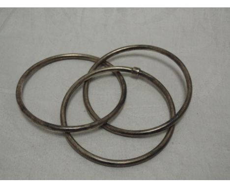 A white metal triple slave bangle stamped 925 of plain tubular form
