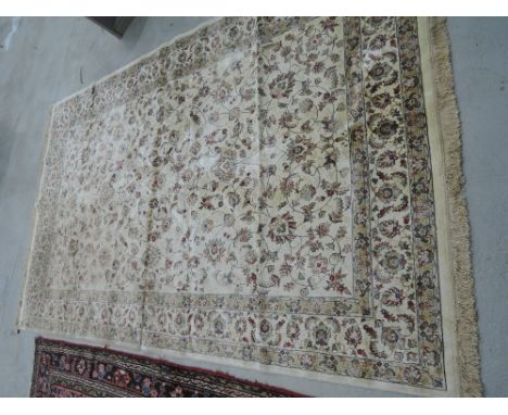 A modern carpet square of silk inspiration having floral design, on cream ground, approx 120in x 76in