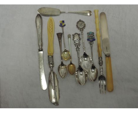 A selection of HM silver flatware including souvenir spoons, butter knives and pickle fork etc