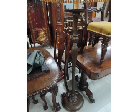 An early/mid 20th century stained frame standard lamp having fringed shade and fluted column