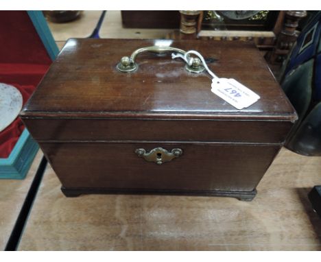 A 19th century mahogany tea caddy of rectangular form having slot interior, on bracket feet
