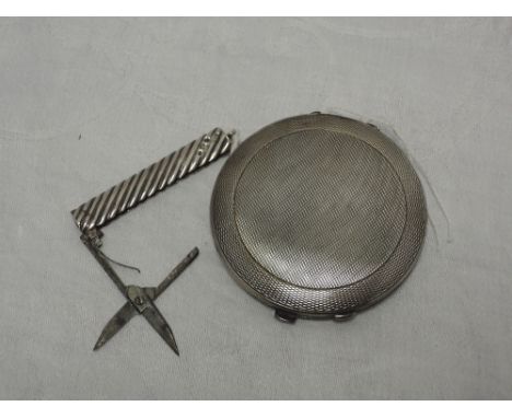 A silver powder compact having engine turned decoration, Birmingham 1940, Charles Green &amp; Co Ltd, and a Victorian pair of