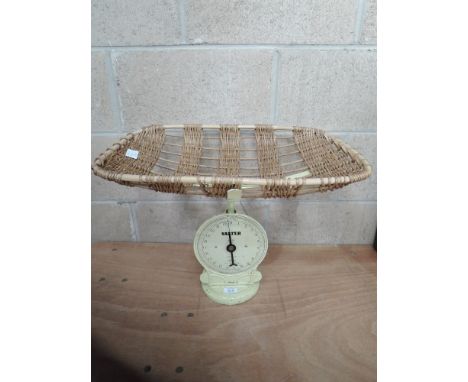 A set of vintage baby scales by Salter, having wicker dish and numbered 50 on cast cream base