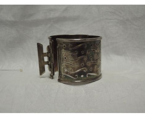 A Scottish silver hinged bangle of broad form having pierced decoration, Edinburgh hallmarks, maker AMSCondition Reportclasp 