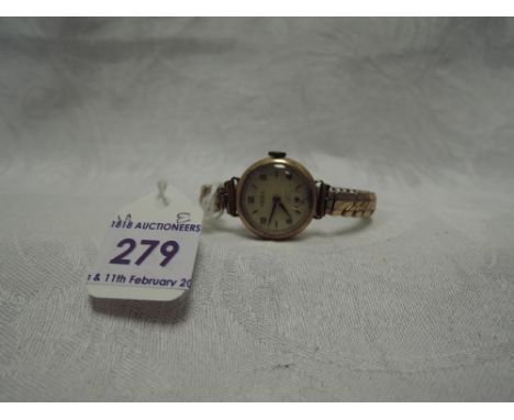 A lady's vintage 9ct gold wrist watch by Trebex having Arabic numeral dial and subsidiary seconds on a gold plated stretch st