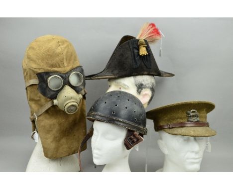A BOX CONTAINING FOUR MILITARY HATS, CAPS, etc, to include a 'Bicorn' hat, WWI British Army Cap with Leicestershire Regiment 