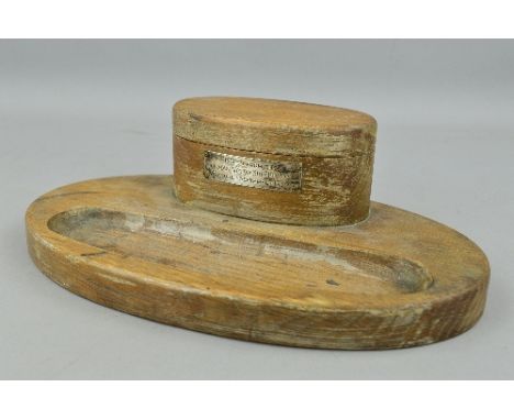 A WOODEN DESK TIDY/ORNAMENT IN WOOD, oval shaped with a shallow tray for pens, pencils etc, standing above is an oval double 