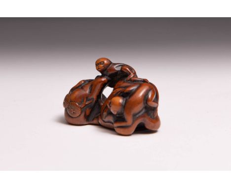 A JAPANESE WOOD NETSUKE OF TWO MONKEYS EDO PERIOD, 18TH/19TH CENTURY The two small primates are depicted clambering upon a ro