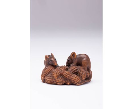 A JAPANESE BOXWOOD NETSUKE MEIJI ERA, 19TH CENTURY Carved as two small rats on a cluster of peanuts, one gnawing on the nuts,