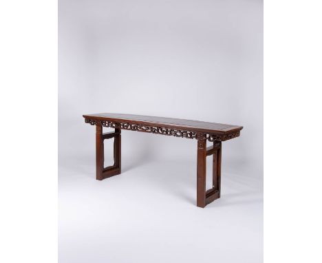A CHINESE HARDWOOD SCROLL TABLE LATE QING DYNASTY The long rectangular top above a pierced frieze of formal scrolls and tied 