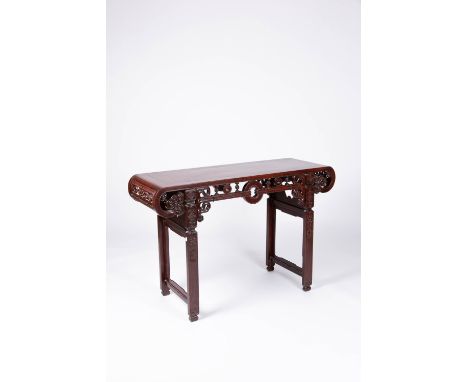 A CHINESE HARDWOOD ALTAR TABLE LATE QING DYNASTY The rectangular top with curved lingzhi scroll ends, the frieze with turned 
