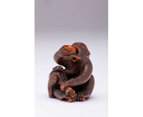 A JAPANESE WOOD NETSUKE OF TWO MONKEYS MEIJI ERA, 19TH CENTURY Carved as an adult and its young, the larger primate seated an