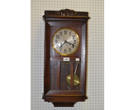 An early twentieth century mahogany wall clock, brass circular dial