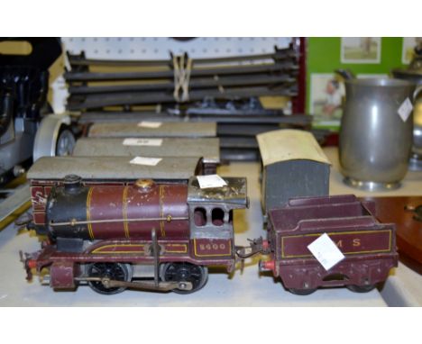 A Hornby 0-4-0 5600 engine and tender ; three passenger carriages, goods carriages 