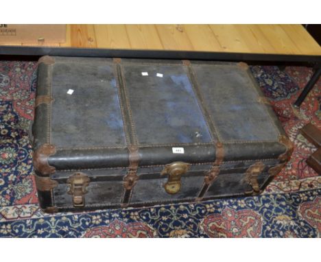 An early 20th century leather and metal bound rectangular travelling trunk, Yale lock 