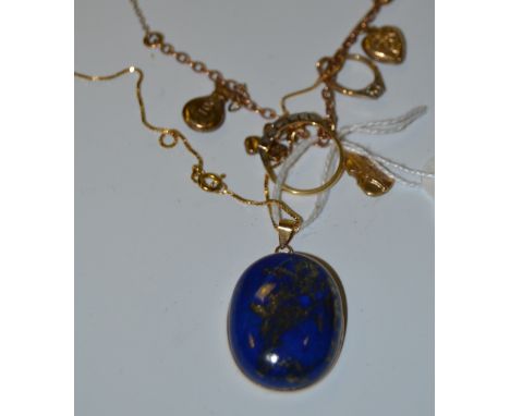 A Lapis Lazuli pendant;  an 18ct gold diamond chip ring;  a 9ct charm bracelet 