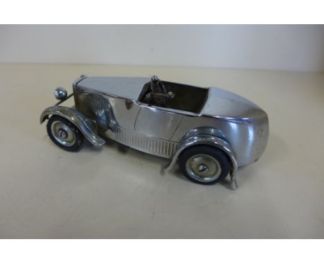 A vintage chrome sports car petrol desk lighter - 16cm long,&nbsp; lighter is not working but action does work -front tyres a