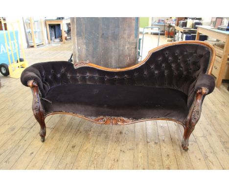 A mid Victorian carved mahogany button back chaise longue
