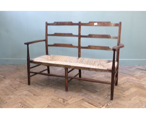 An Edwardian caned two seater bench