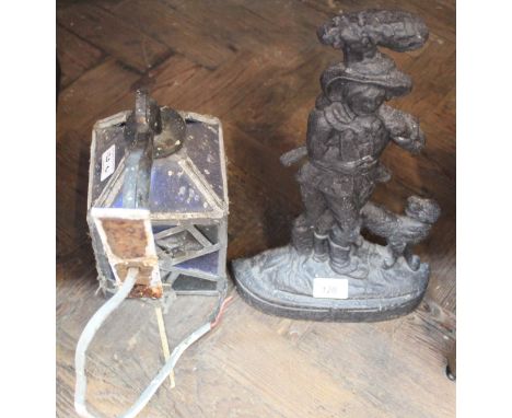 A Victorian iron man and dog doorstop plus a leaded porch lantern