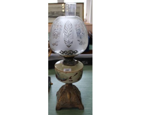 A metal base oil lamp with painted opal glass bowl and etched globe