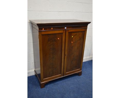 A GEORGIAN MAHOGANY DOUBLE DOOR GENTLEMANS DWARF CUPBOARD, with raised panels, enclosing later hooks and hanging rails, brass