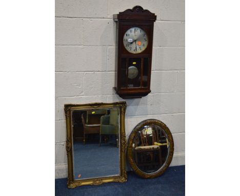 AN EARLY 20TH CENTURY OAK WALL CLOCK (winding key and pendulum) and a gilt framed bevelled edge wall mirror and modern chinoi